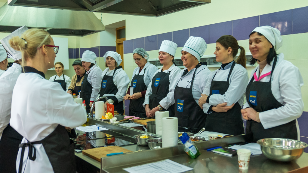 A group of people in a kitchen
Description automatically generated with low confidence