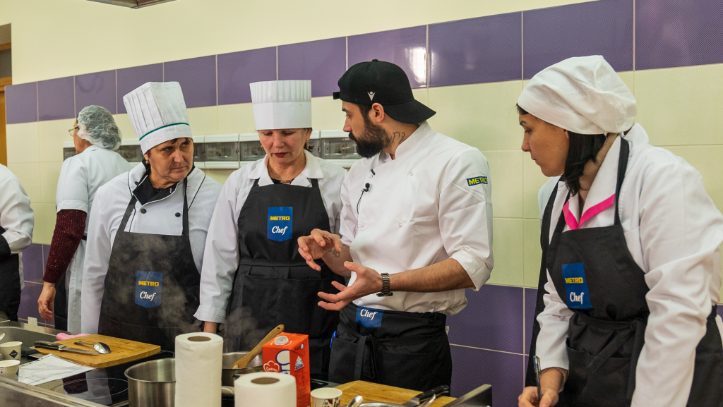 A group of chefs in a kitchen
Description automatically generated with medium confidence